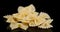 Handful of Farfalle pasta dry on the table slowly rotates.