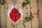 A handful of fresh rosehips in front of wooden desk from above