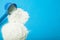 Handful of milk powder with a measuring blue spoon. Space for text