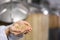 Handful of milled malted grain in hands of female brewmaster