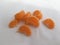A handful of ripe mandarin slices. Abstract minimalistic shot.