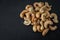 Handful of roasted cashew nuts on black background