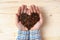 Handful of roasted coffee beans heart shaped pile