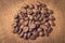 A handful of roasted coffee beans on a wooden table