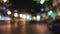 handheld blurred background through windshield in city at night