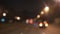 handheld blurred background through windshield in city at night