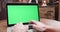 Handheld dynamic shot of fast typing on a laptop with green screen