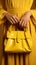 Handheld flair woman gracefully clutches yellow tote, infusing color into her ensemble