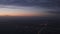 Handheld shot flying on airplane over night citys grainy