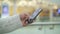 Handheld shot of male hand scrolling a phone on blurred yellow background