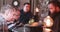 Handheld shot of three men sitting at the bar counter