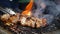 Handheld, slow motion close up of smoky pork belly skewers on a fiery charcoal hibachi grill