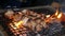 Handheld, slow motion close up of smoky pork belly skewers turning on a fiery charcoal hibachi grill