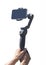 Handheld smartphone stabilizer in the hands. Blogger shoots video on smartphone