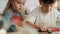 Handheld video of children cutting out gingerbread cookies.