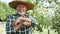 Handheld video portrait of happy farmer in a straw hat.