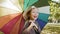 Handheld view of joyful girl looking for shelter with umbrella