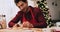 Handheld view of man decorating Christmas cookies