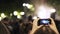 Handheld of a woman filming a festival in Toledo, Spain