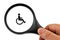 Handicap concept with magnifying glass on white background