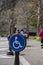 A handicap sign painted on asphalt street near the park.