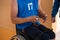 a handicapped basketball player prepares for a match while sitting in a wheelchair.preparations for a professional