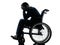 Handicapped man head in hands in wheelchair silhouette