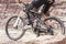 Handicapped mountain bike rider between rocks