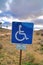 Handicapped parking sign against desert grassland at Joshua Tree National Park