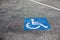 Handicapped parking spot, blue square on asphalt