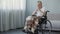 Handicapped person sitting in wheelchair and thinking about life, depression