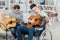 Handicapped teenager and friend playing guitar