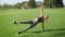 Handicapped woman doing plank on hand in field. Girl practicing yoga outdoors