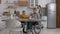 Handicapped woman having breakfast in home kitchen