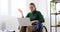 Handicapped woman video conferencing on laptop