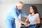 Handicapped young woman with mature female doctor in clinic