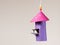 Handicraft of a colorful bird house and a small bird made of toilet paper roll by a child