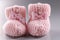 Handicraft shoes for newborn baby on grey background