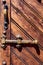 Handle and bolt of an old wooden door.