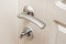 A handle with a white entrance door lock made in wood
