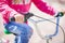 Handlebar of a child`s bicycle close up. The child holds the handlebars of the bike. Healthy lifestyle concept