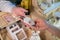 Handmade Aromatic Sachet Sale: A woman at a market hands over artisanal sachet to a customer, showcasing craftsmanship