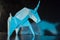 Handmade blue unicorn on shiny background, selective focus