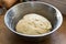 Handmade bread dough rising in a bowl
