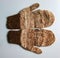 Handmade brown-beige mittens from Argentinean merino wool on a white background