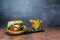 Handmade burger with fries and on dark background