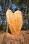 Handmade carved wooden heart into a tree trunk, piece of wood turned into a wooden heart art.