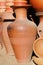 Handmade ceramic clay brown terracotta amphora souvenirs at street handicraft market.