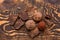 Handmade chocolate candies and pieces of chocolate on wooden background