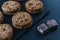 Handmade chocolate chip cookies and cocoa pieces on a chalkboard table